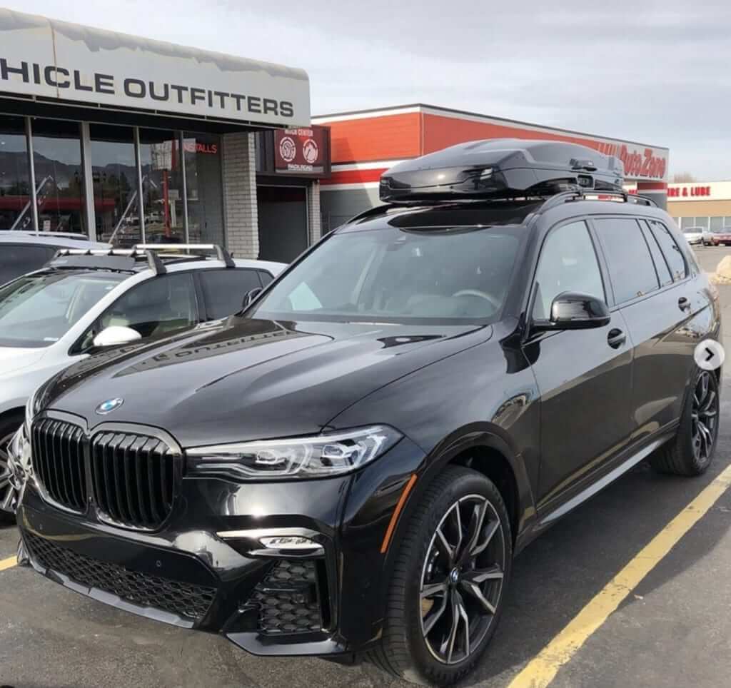 BMW X5 loaded with Thule's Motion Rooftop Cargo Box