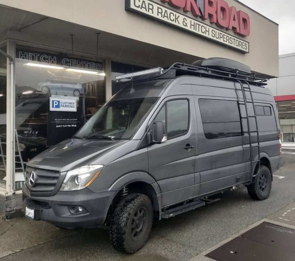 Mercedes Sprinter Van equipped with cargo box and access ladder rack n road