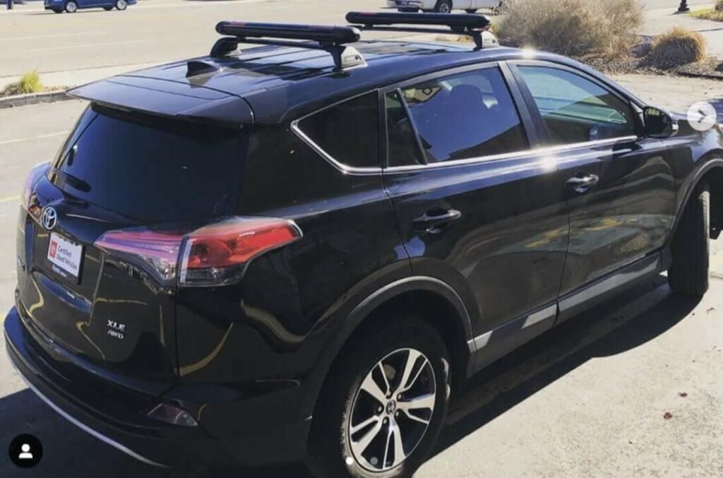 Toyota Rav4 outfitted with Tailored Fit Whispbar Roof Rack and Yakima FatCat Evo Ski & Snowboard Rack Rack N Road
