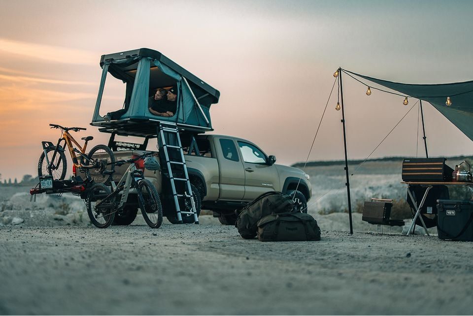 Pickup truck with Thule rooftop tent and gear